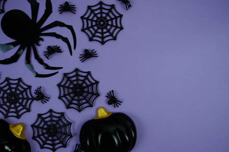 Halloween background with a large black spider, spiderwebs, and a purple background for Halloween...