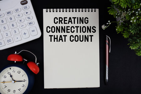 Creating Connections That Count text with calculator with alarm clock on black backgroundの写真素材