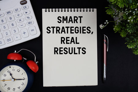 Smart Strategies, Real Results text with calculator with alarm clock on black backgroundの写真素材