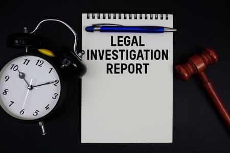 Legal Investigation Report text written on notepad with gavel and alarm clock on black backgroundの写真素材