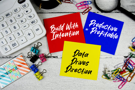 Build With Intention, Productive = Profitable, Data Drives Direction text written on paper note with...