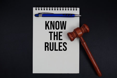 Know The Rules text written on notepad with gavel on black backgroundの写真素材