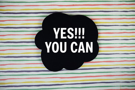 Yes You Can text with speech bubble top view on colorful stripes background