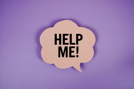 Help Me! text with speech bubble top view on purple backgroundの写真素材