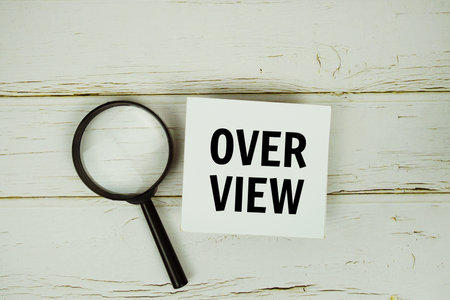 Over View text with magnifying glass on wooden backgroundの写真素材