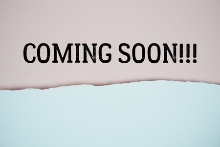 Coming Soon!!! text on pink with white paper torn ripped of horizontalの写真素材