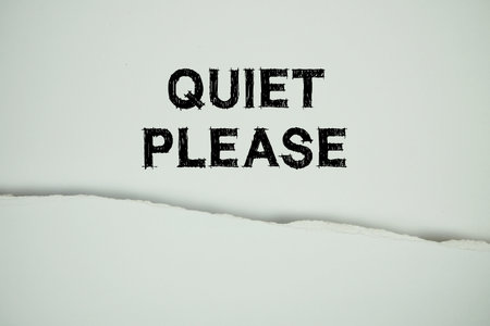 Quiet Please text on white with white paper torn ripped of horizontalの写真素材