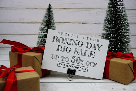 Festive display with small decorative Christmas trees and gift box present with "Special Offer Boxing Day Big Sale up to 50% off, Promotion Holiday Sale Eventの写真素材