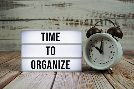 Time to Organize text with alarm clock on wooden backgroundの写真素材