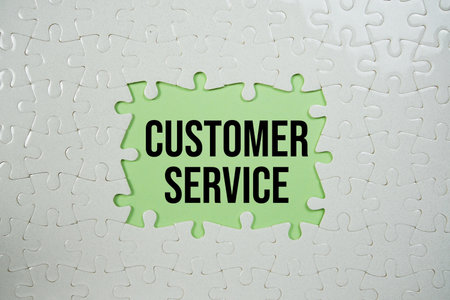 Jigsaw puzzle with a missing piece with "Customer Service" on green backgroundの写真素材