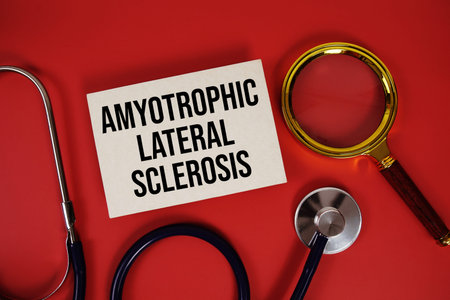 Amyotrophic Lateral Sclerosis text written on paper card with stethoscope and magnifying glass on...