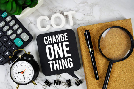 COT - Change One Thing acronym with calculator, alarm clock and magnifying glass, business concept...