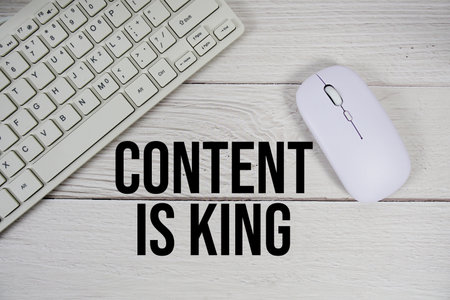 Content Is King text with keyboard and wireless mouse on wooden backgroundの写真素材