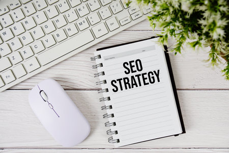 SEO strategy text with keyboard and wireless mouse on wooden backgroundの写真素材