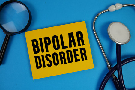 Bipolar Disorder text with Stethoscope and magnifying glass on blue backgroundの写真素材