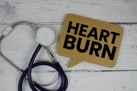 Heart Burn text with Stethoscope on wooden backgroundの写真素材