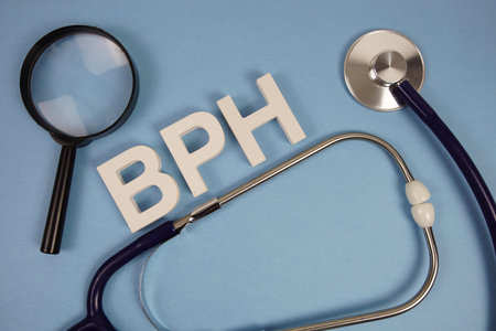 BPH Benign Prostatic Hyperplasia text with Stethoscope and magnifying glass on blue backgroundの写真素材