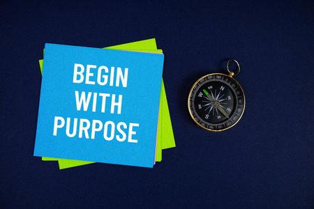 Begin With Purpose text written on sticky note with compass on blue  backgroundの写真素材