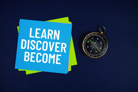 Learn Discover Become text written on sticky note with compass on blue  backgroundの写真素材