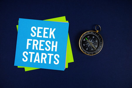 Seek Fresh Starts text written on sticky note with compass on blue  backgroundの写真素材