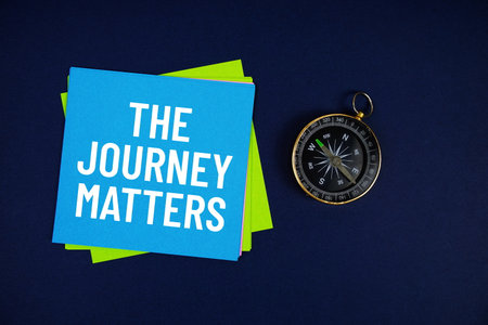 The Journey Matters text written on sticky note with compass on blue  backgroundの写真素材