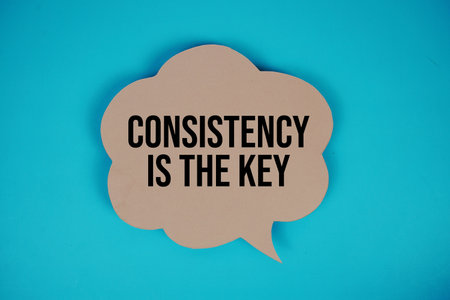 Consistency Is The Key text with speech bubble top view on blue backgroundの写真素材