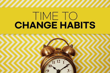 Time to Change Habits text with alarm clock on yellow backgroundの写真素材
