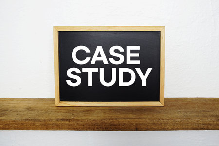 Case Study text written on blackboard with wooden shelf and concrete backgroundの写真素材