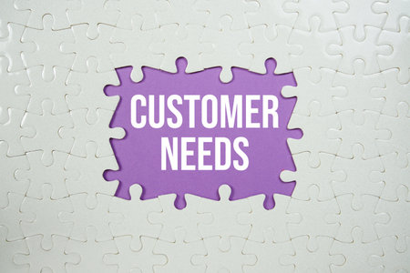 Jigsaw puzzle with a missing piece with "Customer Needs" on purple backgroundの写真素材