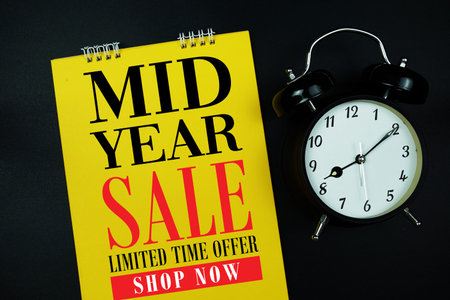 Mid Year Sale text with alarm clock on black background