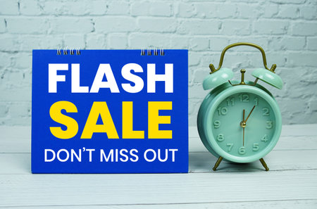 Flash Sale text Promotion and Marketing with alarm clock on wooden background