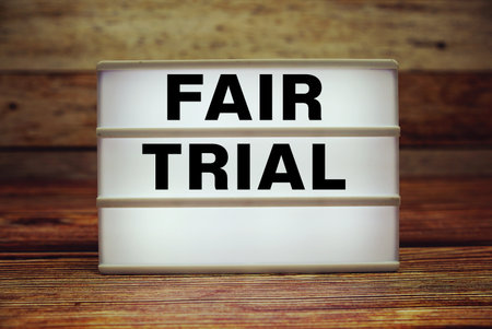Lightbox with text "Fair Trial" on wooden backgroundの写真素材