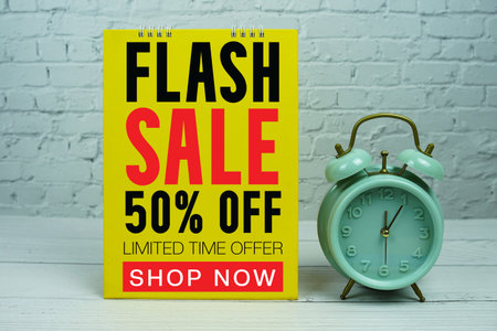 Flash Sale text Promotion and Marketing with alarm clock on wooden background