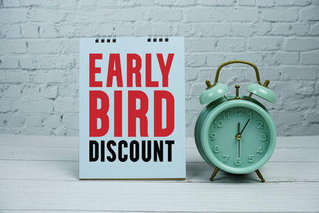 Early Bird Discount text Promotion and Marketing with alarm clock on wooden background