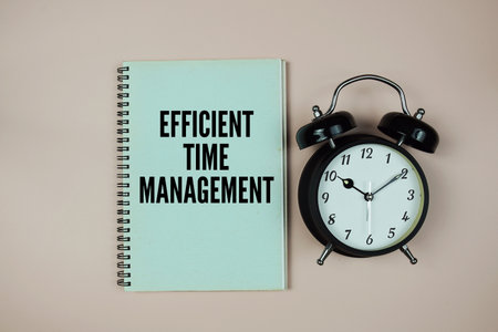 Motivational Message with Alarm Clock "Efficient Time Management" on pink backgroundの写真素材