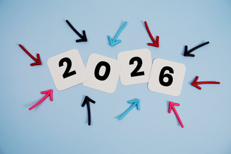 Happy New Year 2026 on cards with colorful arrows pointing toward it on blue backgroundの写真素材