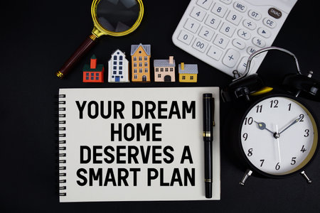 Notepad with the phrase Your Dream Home Deserves A Smart Plan surrounded by a pen, calculator,...