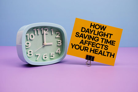 How Daylight Saving Time Affects Your Health text and alarm clock on blue and purple background