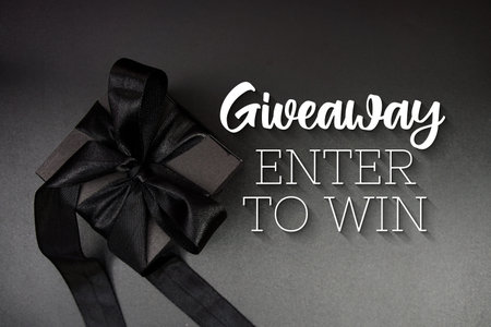 Giveaway Enter To Win text with gift box present and alarm clock on black background