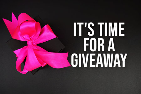 It's Time For A Giveaway text with gift box present on black background