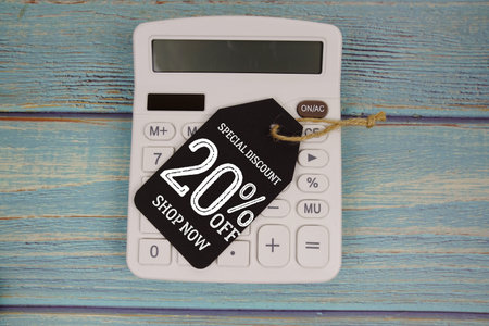 Special Discount 20% off Shop Now with price tag and calculator on wooden background