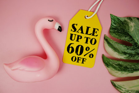 Price tag Sale 60% with summer decorations on pink backgroundの写真素材
