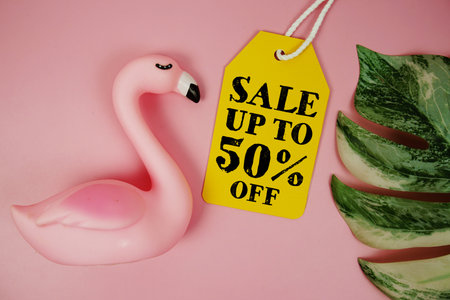Price tag Sale 50% with summer decorations on pink backgroundの写真素材