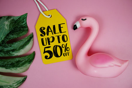 Price tag Sale 50% with summer decorations on pink backgroundの写真素材