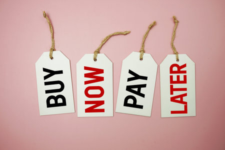Price tag with "Buy Now Pay Later" is placed on pink backgroundの写真素材
