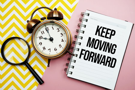 text written on notepad with alarm clock and magnifying glassの写真素材