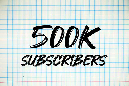 500k Subscribers text written on white notebook sheet with gridの写真素材
