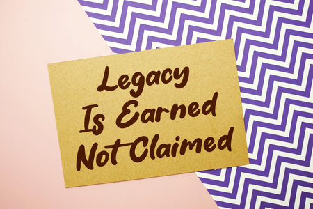 Legacy Is Earned Not Claimed text written on pink backgroundの写真素材