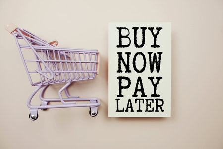 Buy Now Pay Later and Mini Shopping Cart on Pastel Backgroundの写真素材