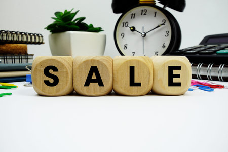 SALE alphabet letters with alarm clock and calculator on white backgroundの写真素材